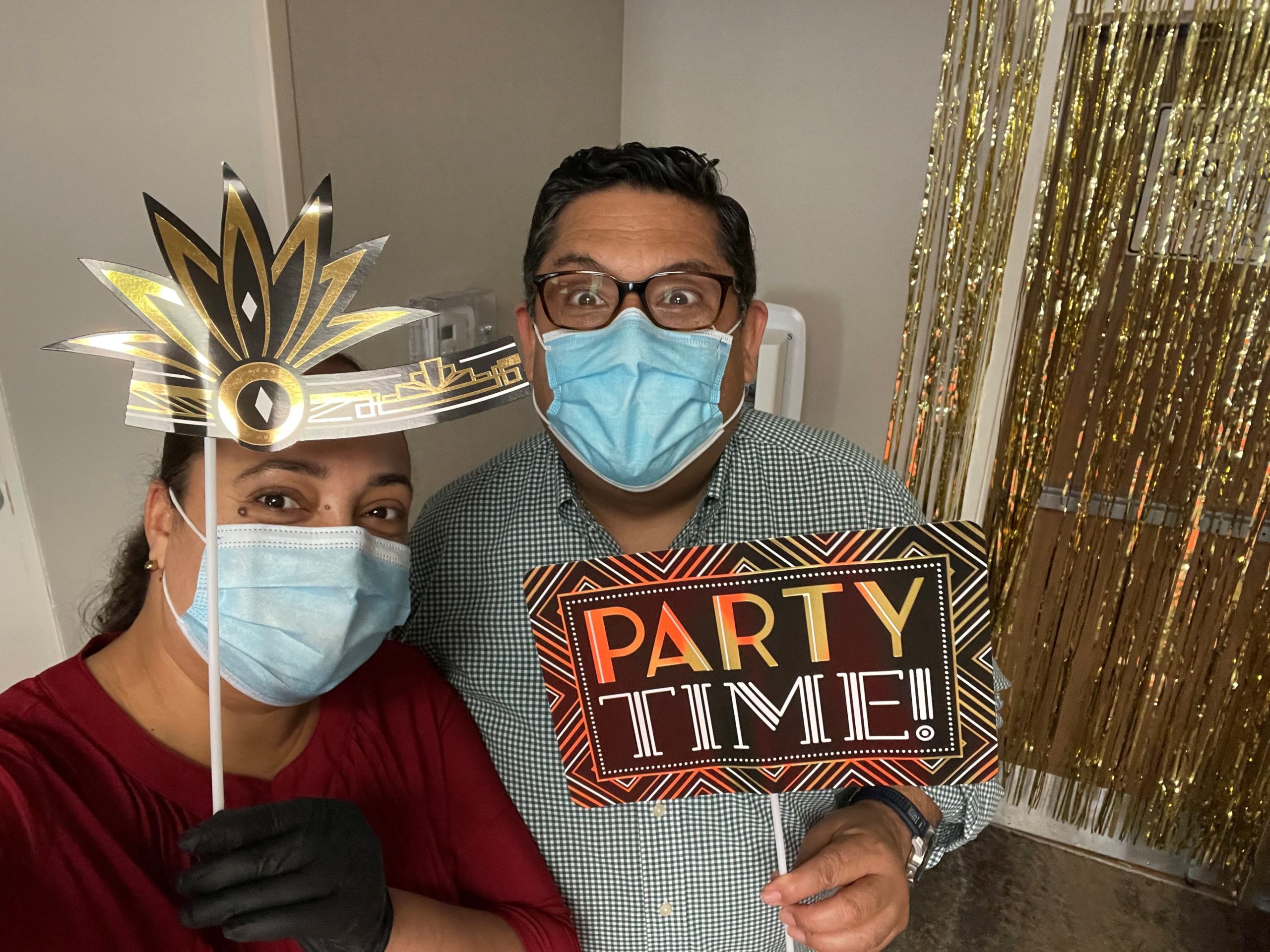 People wearing masks and holding party signs